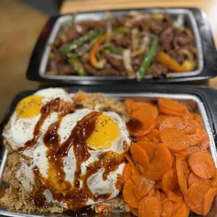 Korean Pepper steak (ribeye), with fried eggs on top of fried rice and sweet carrots.