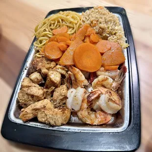 Hibachi chicken and shrimp half rice half noodles. Add carrots