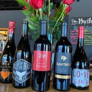 a variety of wine bottles and flowers