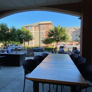 a patio with tables and chairs