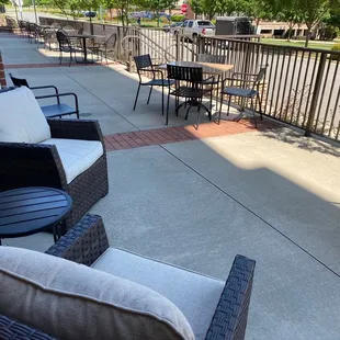 a patio with chairs and tables