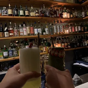 a person holding a glass of alcohol