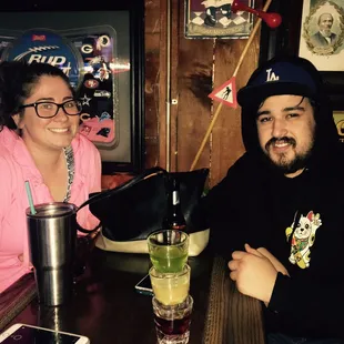 a man and a woman sitting at a bar