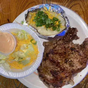 16oz ribeye, baked potato and salad