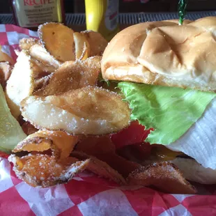 A cheese burger with chip fries.