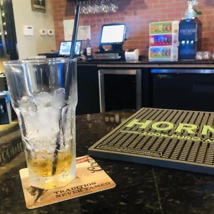 a glass of whiskey on a bar
