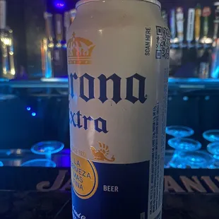 a can of corona beer on a bar