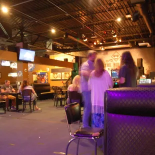 people sitting at tables in a restaurant