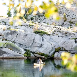Photo by Jessica Lillian Photography- www.jessicalillianphotography.com.  Bride and groom floating on the lake in a canoe