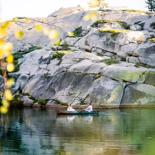 Photo by Jessica Lillian Photography- www.jessicalillianphotography.com - Bride and groom floating in the canoe on the lake