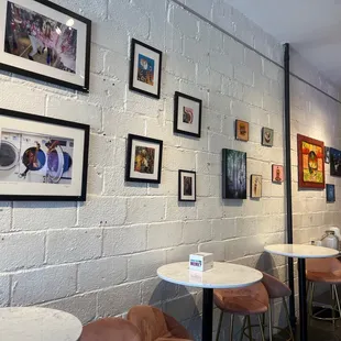 a white brick wall with pictures on it