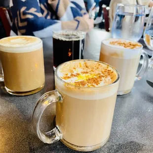 three cups of coffee on a table