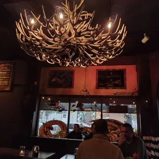 a restaurant with antlers hanging from the ceiling