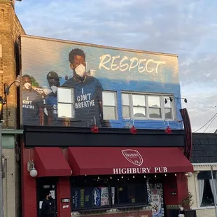 a man in a face mask on the side of a building