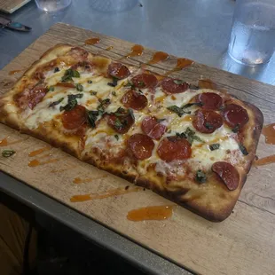 a pepperoni pizza on a cutting board
