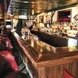 a bar with red leather chairs