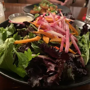 a salad with carrots and radishes