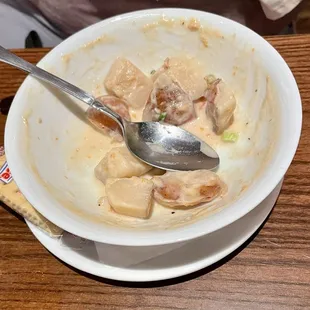 Bowl of leftover potatoes in the New England Clam Chowder - too many potatoes. Cup of chowder does not have so many.