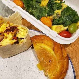 a plate of food and a container of salad