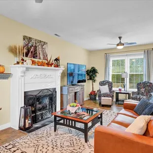 Newly remodeled Sitting Room with fireplace, couches and a coffee bar