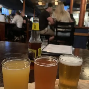 three beers on a wooden tray