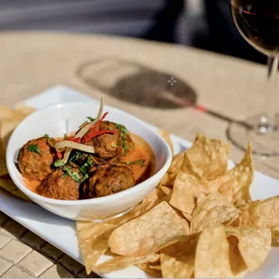 a plate of food and a glass of wine