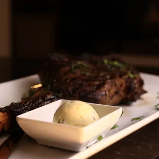a plate of steak with a scoop of ice cream
