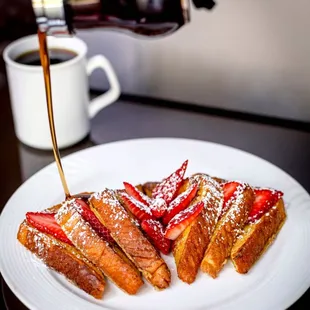 a plate of french toast with strawberries