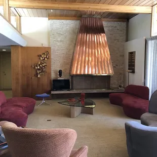 The living room.  Original fireplace and hood.