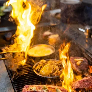 steaks being cooked on a grill