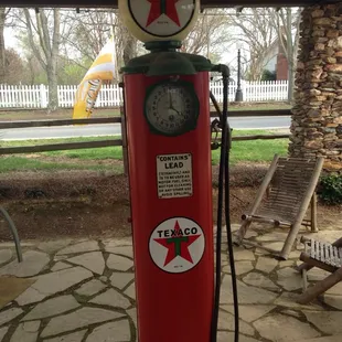 Old pump in front of one of the buildings