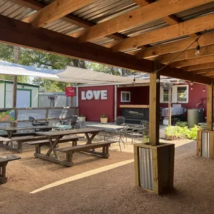 a picnic area with tables and umbrellas