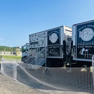 two trucks parked behind a fence