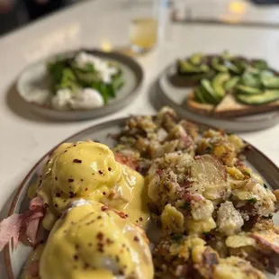 Not so Boring Benedict with avocado and seasonal pesto toast with poached eggs in the back!