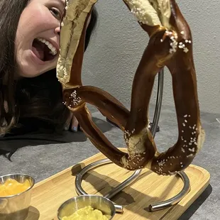 a woman holding a pretzel