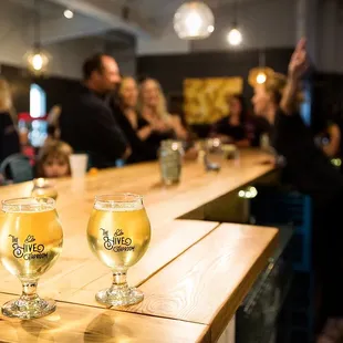 two glasses of beer on the bar