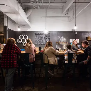 a group of people sitting at a bar