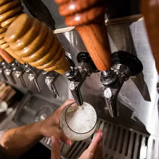a person pouring a beer