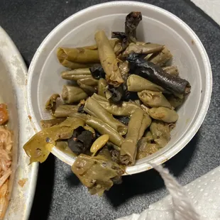 a bowl of pasta and a bowl of green beans