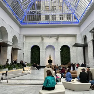 a group of people sitting in a lobby