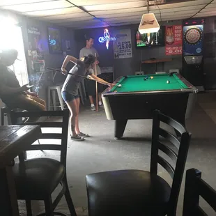 a woman playing pool