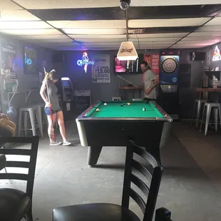 two people playing pool