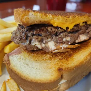 a grilled cheeseburger and french fries