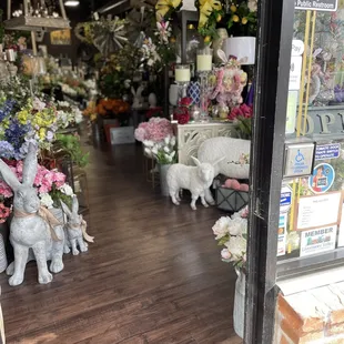 The bunny looks as though it might say "Hello" - maybe a bit Alice of Wonderland theme too. Beautiful arrangements