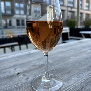 a glass of wine on a wooden table
