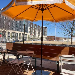 a table and chairs under an umbrella
