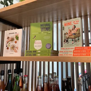 a shelf of wine and books