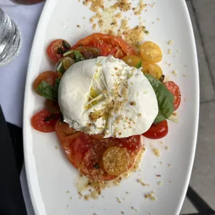 Heirloom Tomato and Burrata Salad (swap out the shaved onions for capers, you won&apos;t regret it). YUM!