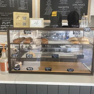 a bakery counter with a variety of pastries