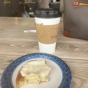 a piece of cake on a plate next to a cup of coffee